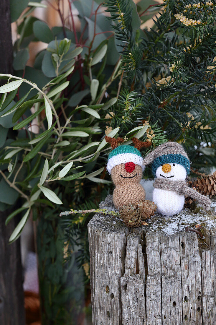 Knitted winter decorations in shapes of snowman and reindeer
