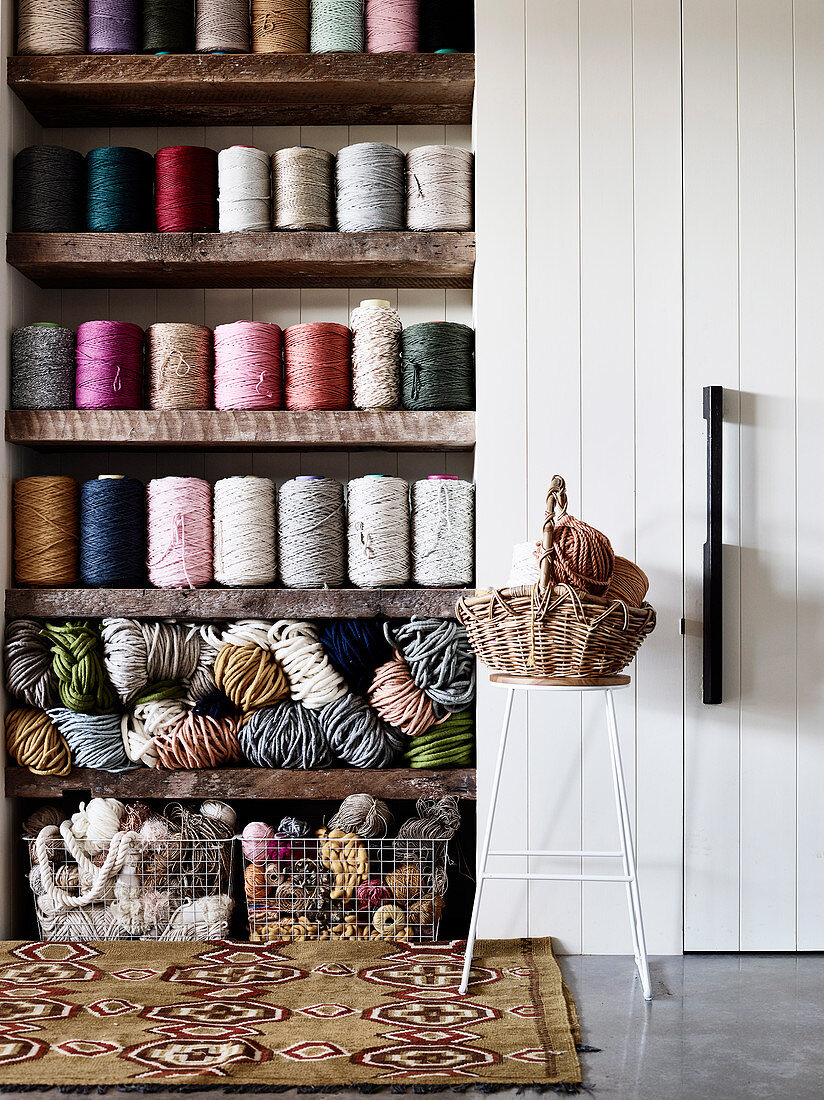 Balls of wool and yarn on a shelf and in metal baskets