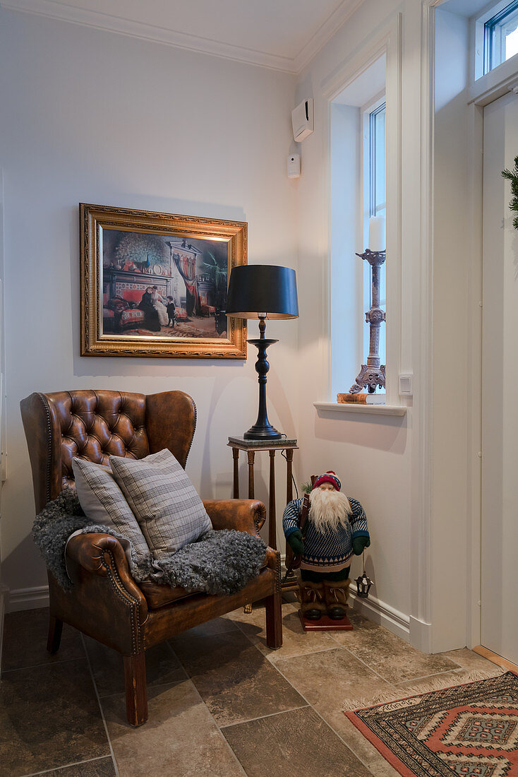 Leather armchair and wintry decorations in classic foyer