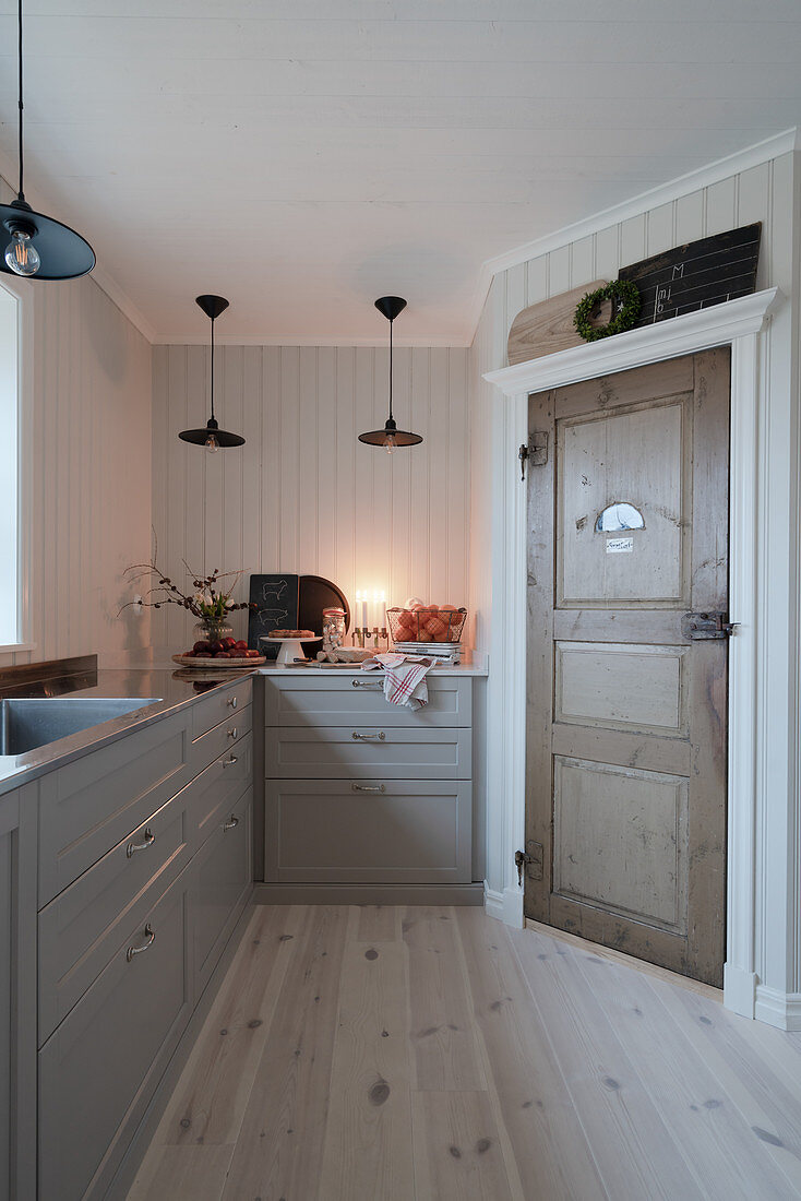 Old wooden pantry door in Scandinavian country-house kitchen