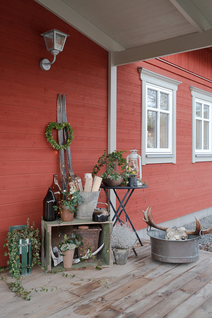Rustic winter decorations on roofed terrace of Swedish house