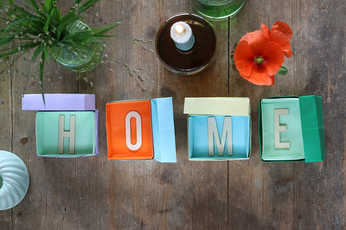 The word 'Home' made from letters in small boxes made from coloured paper