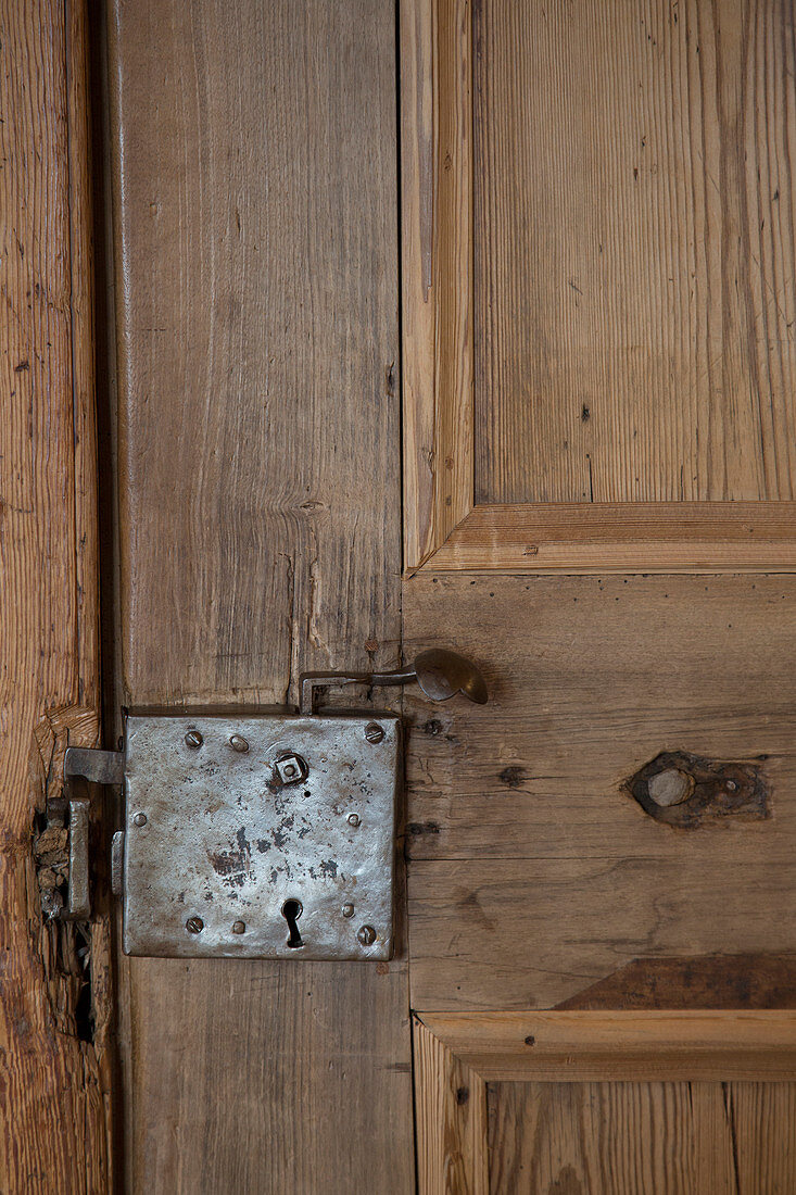 Antique, wooden panelled door with old fittings