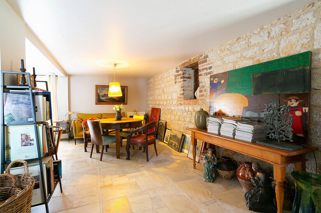 Stone wall and bric-a-brac in rustic dining room