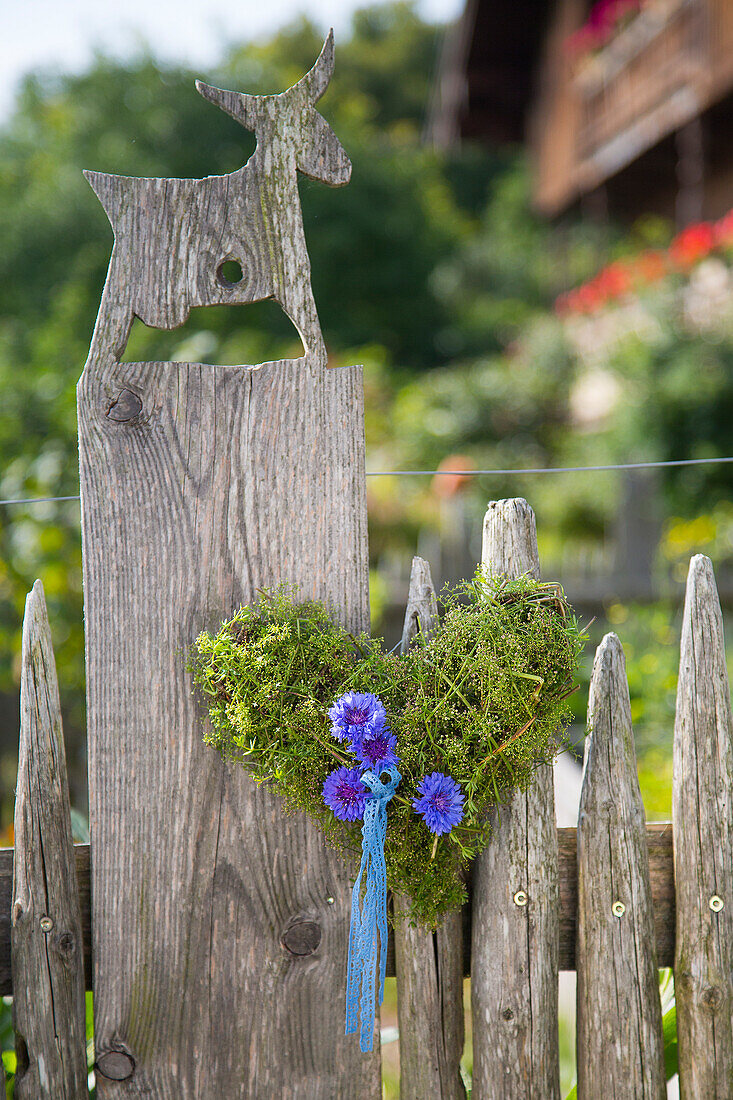 Moss heart decorated with cornflowers