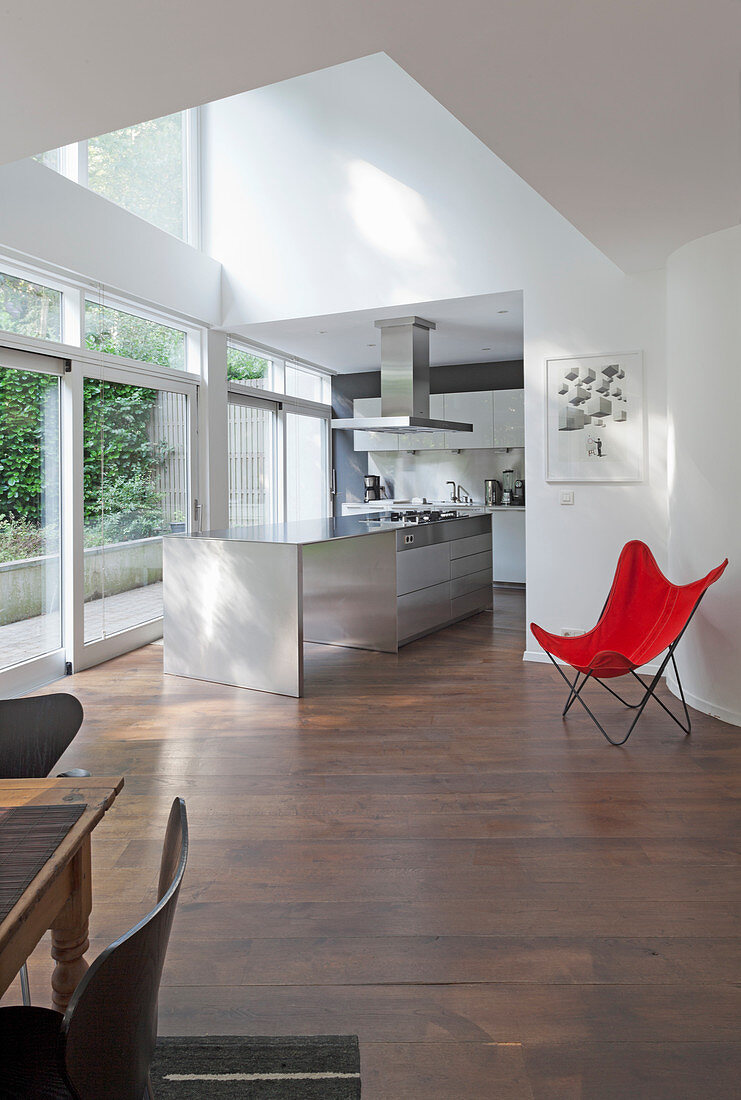Classic, red Butterfly Chair in open-plan kitchen with island counter