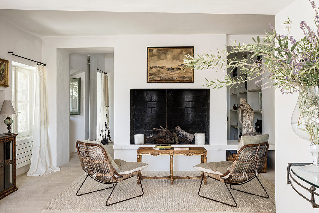 Vintage armchairs in front of fireplace in farmhouse
