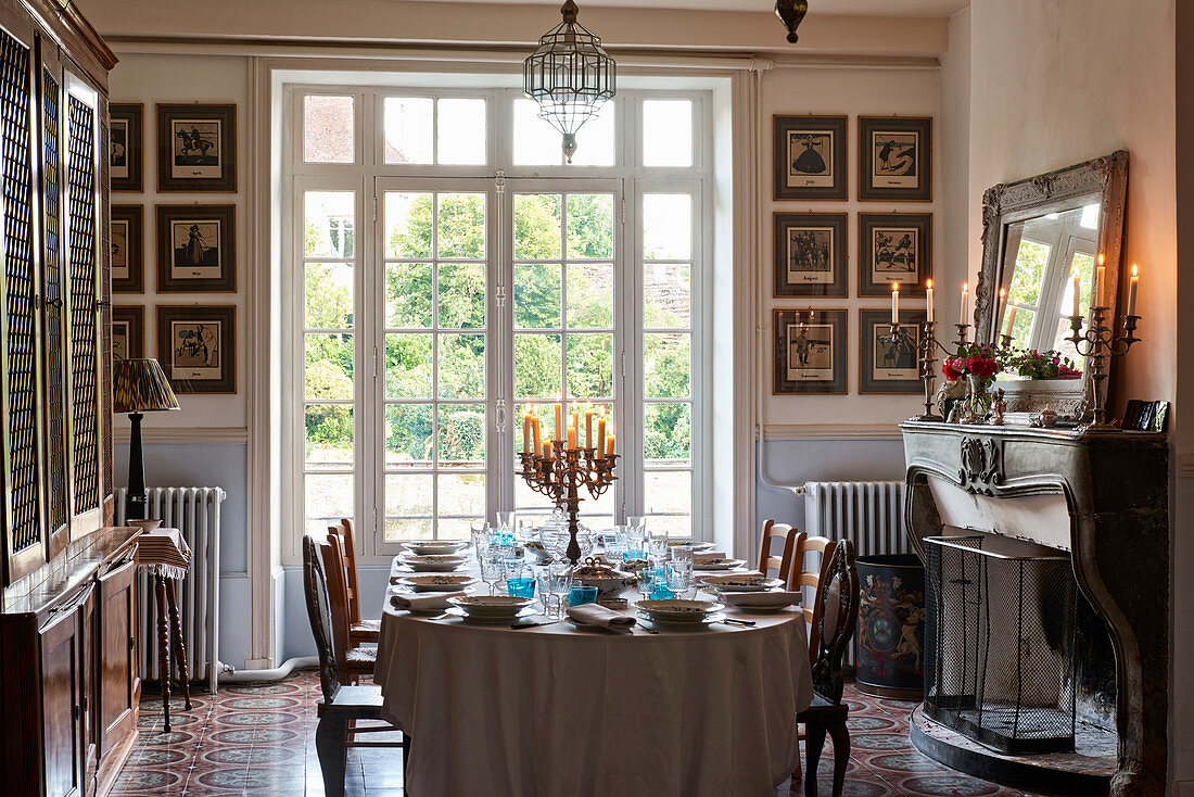 Georgian table set with porcelain crockery and old English candlesticks