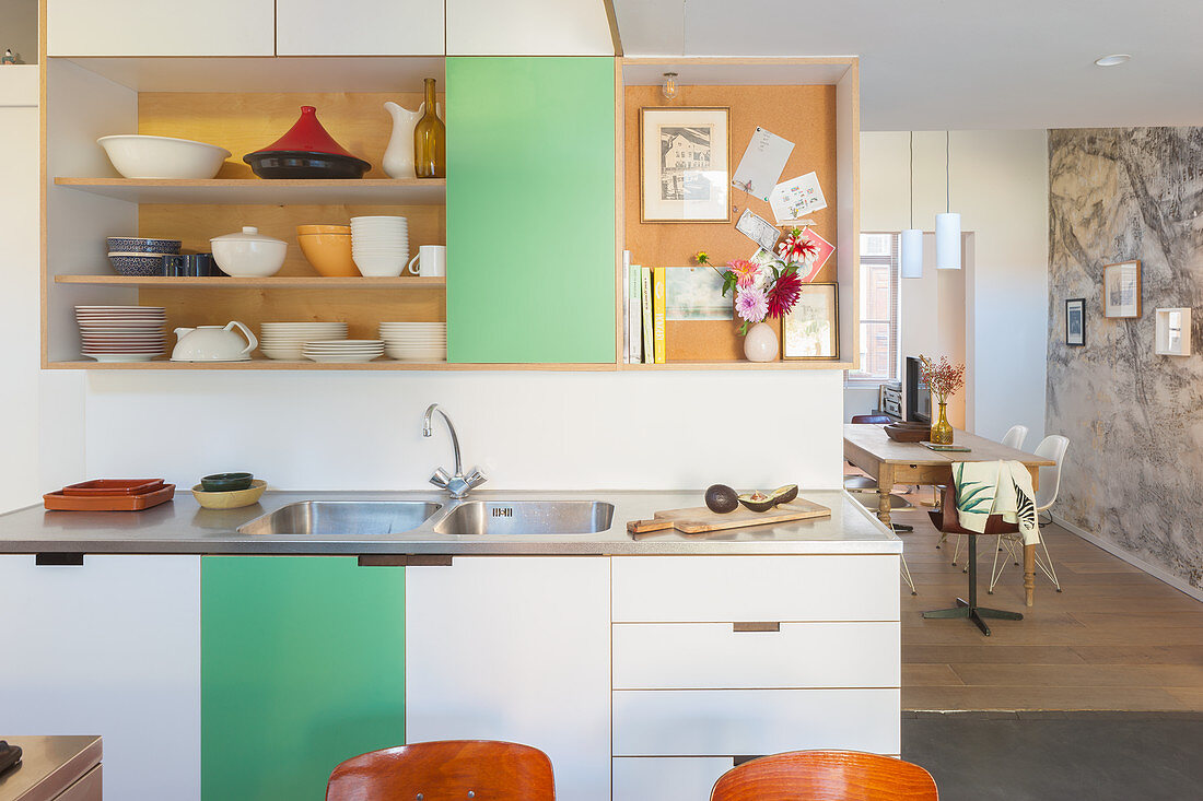 Kitchen counter, shelves and green-and-white cabinets