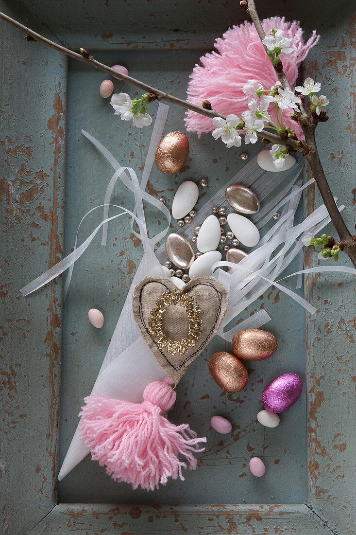 Romantic Easter arrangement of chocolate eggs and pin tassels