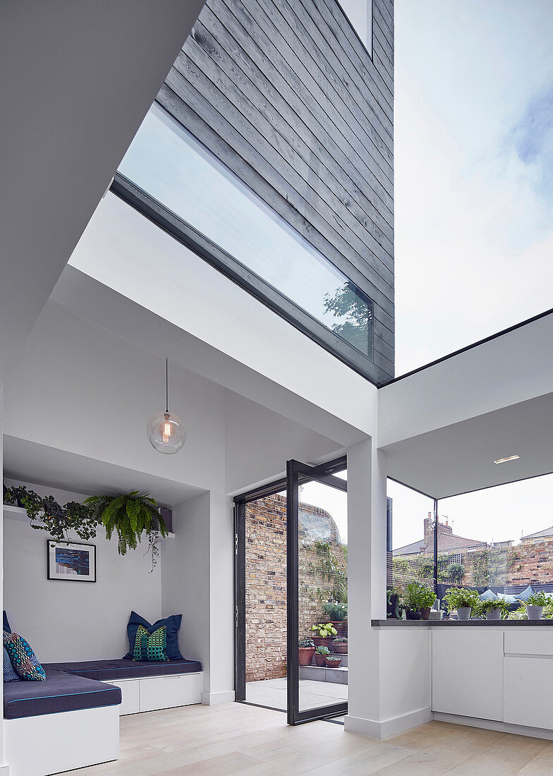 Three-storey architect-designed house with black wood cladding and glass elements
