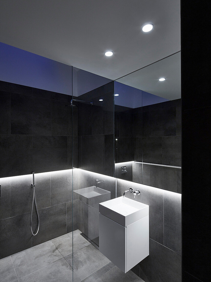 Large tiles, cubic washstand and walk-in shower in designer bathroom