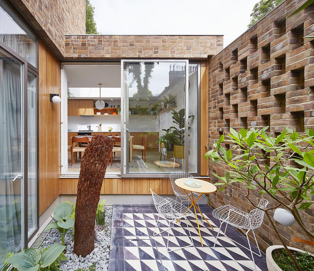 Small, imaginatively designed courtyard of brick house