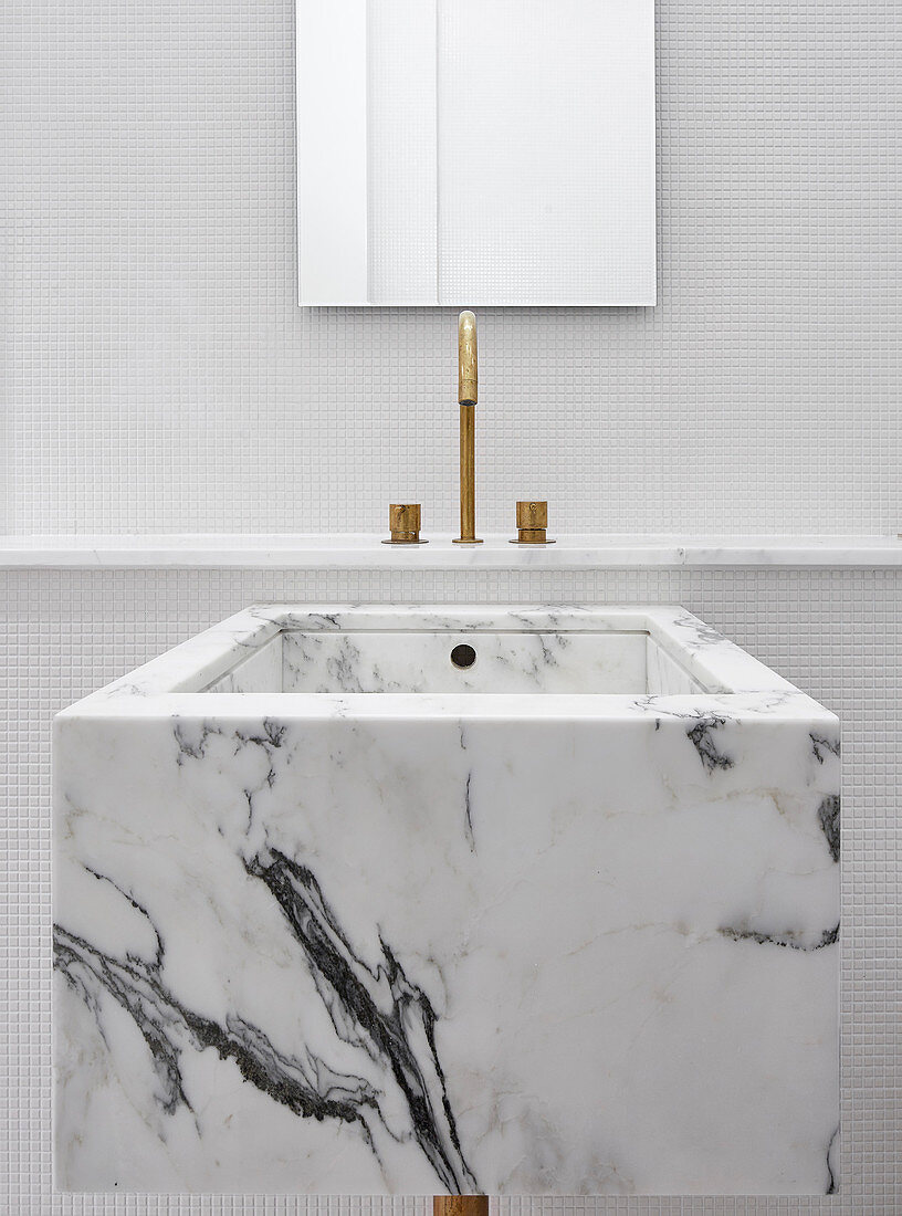 Cubic marble sink in white minimalist bathroom