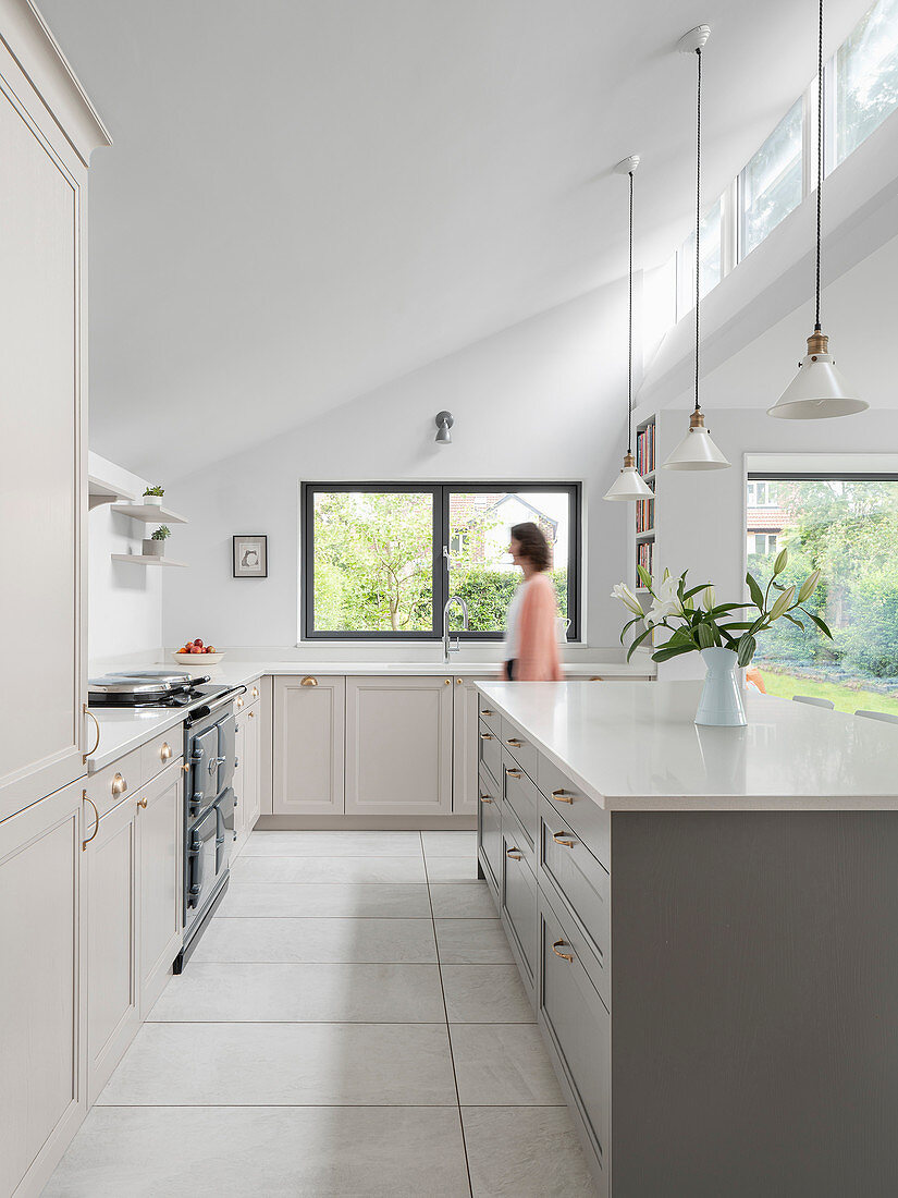 Moderne Landhausküche mit hellgrauen Fronten und hoher Decke