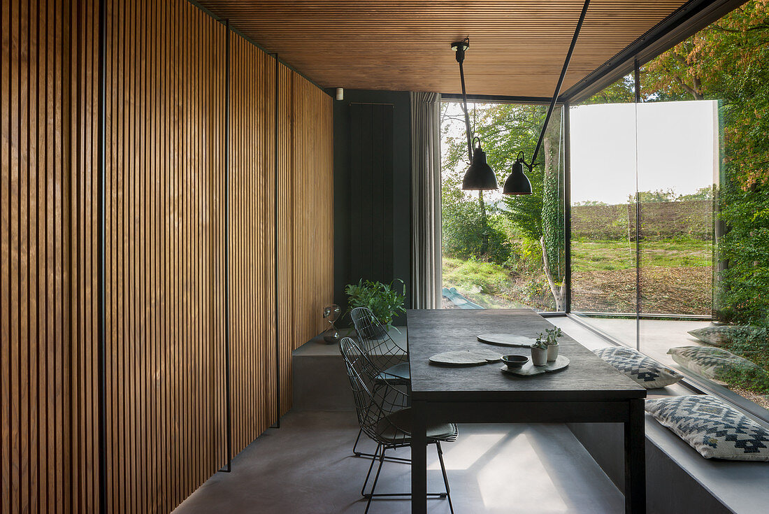 Wood-clad dining area with panoramic windows