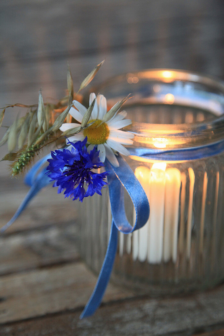 Lantern with marguerite daisies, cornflower, and oats