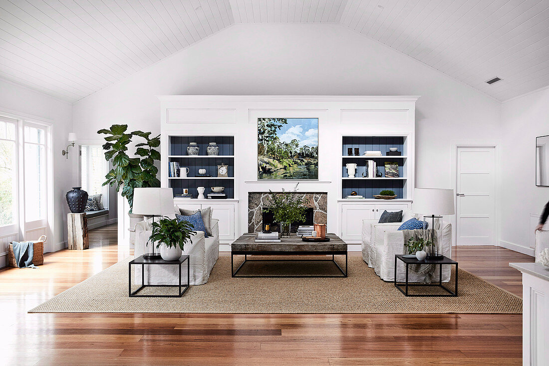Open living room with upholstered set, side tables, coffee table and white living room cupboard