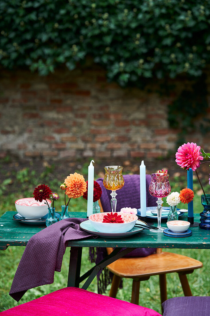 Dahlias on festively set table outdoors