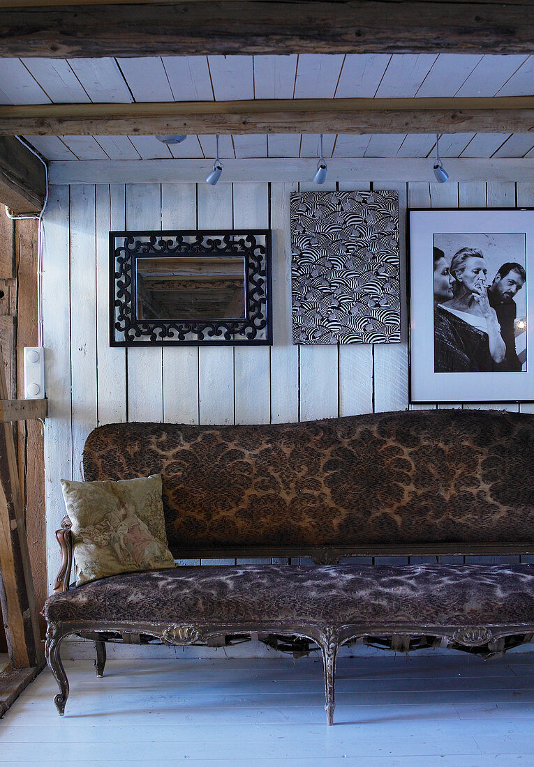 Antikes Barock-Sofa im rustikalen Holzhaus vor der Bretterwand