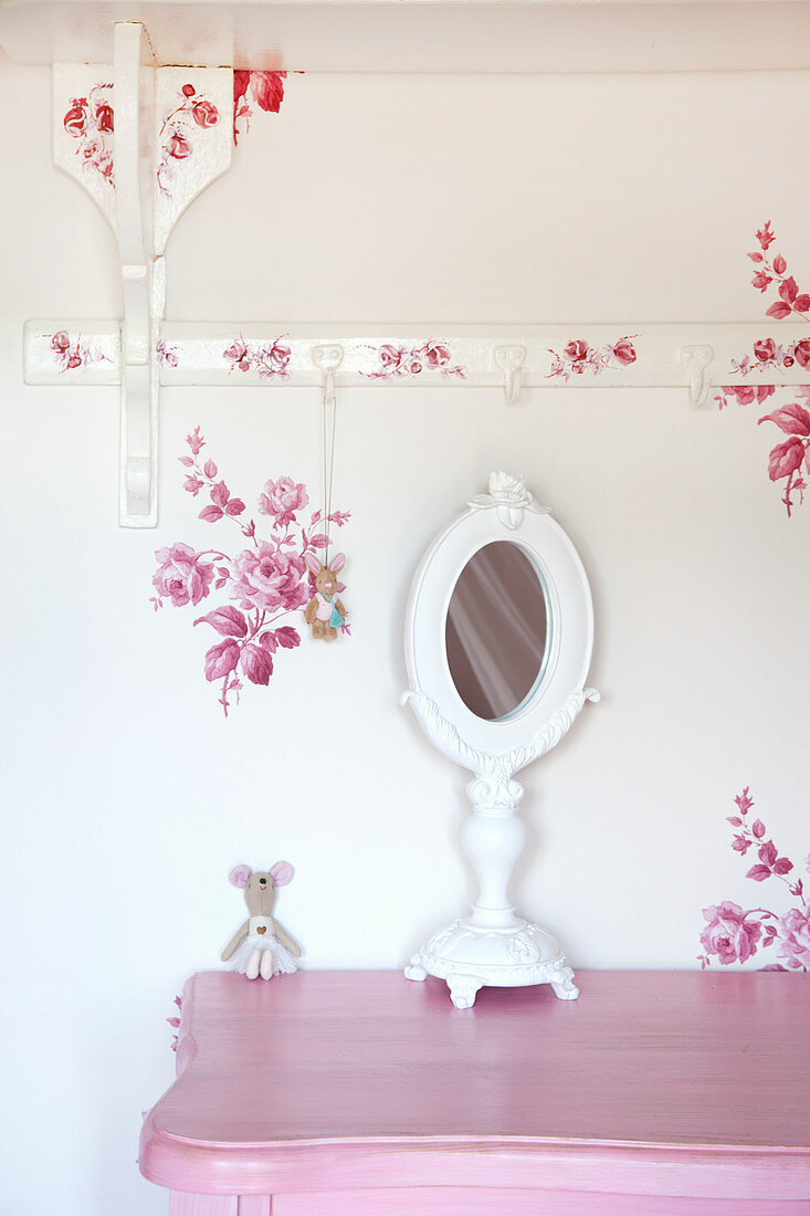 Weißer Tischspiegel auf rosa Kommode