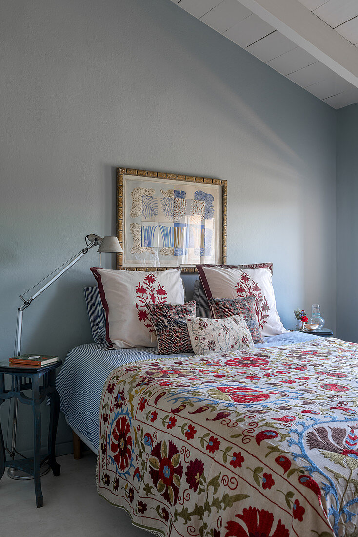 Guest rooms with a lavishly embroidered bedspread and pillows