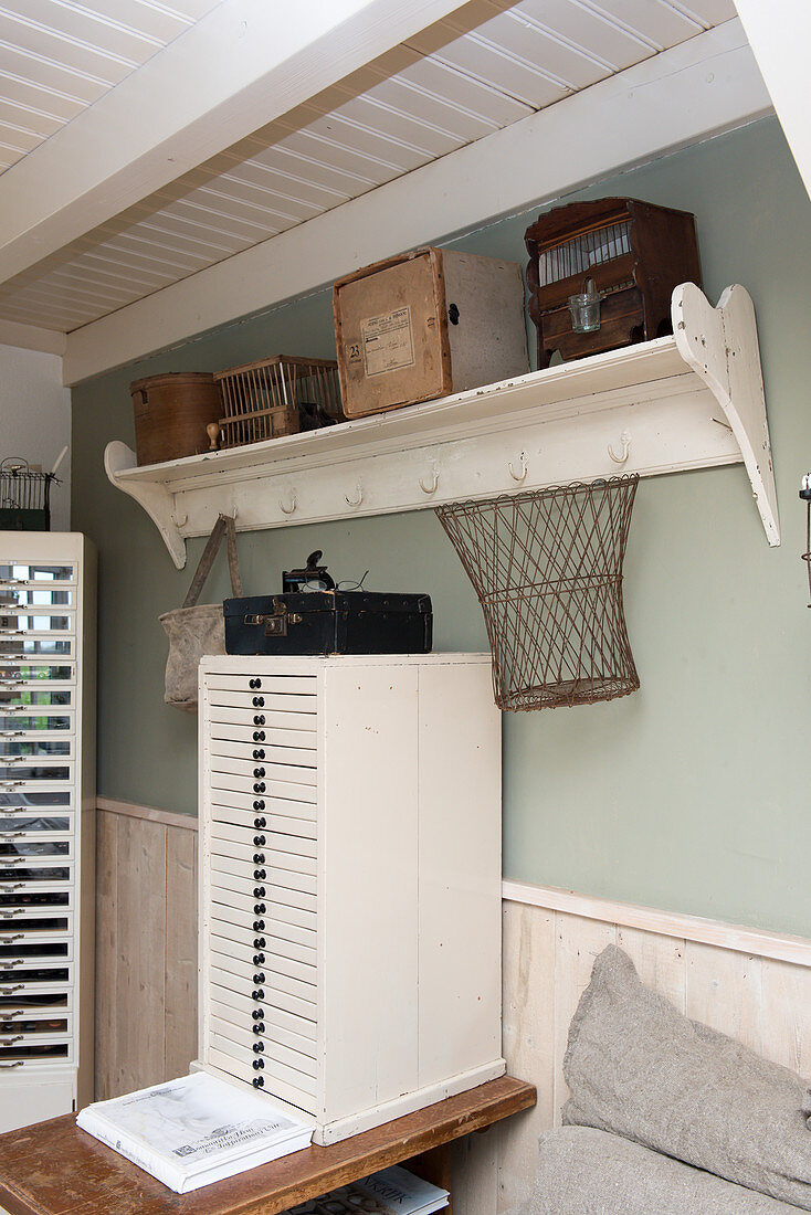 A vintage drawer unit under a coat rack