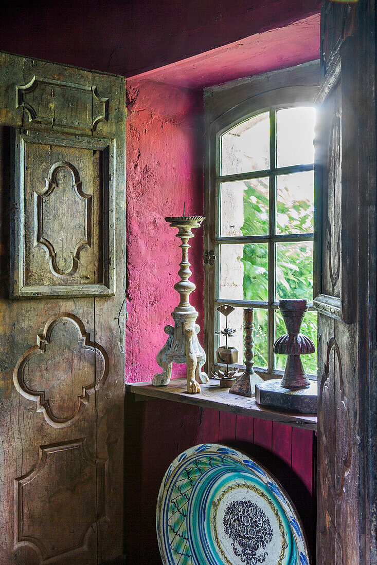 Candlesticks on windowsill and antique shutters