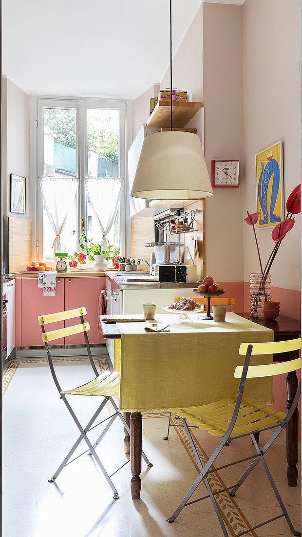 A table with garden chairs in a bright kitchen