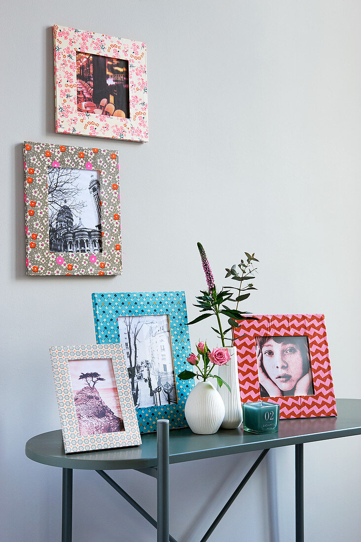 Pictures in decorated frames on and above console table