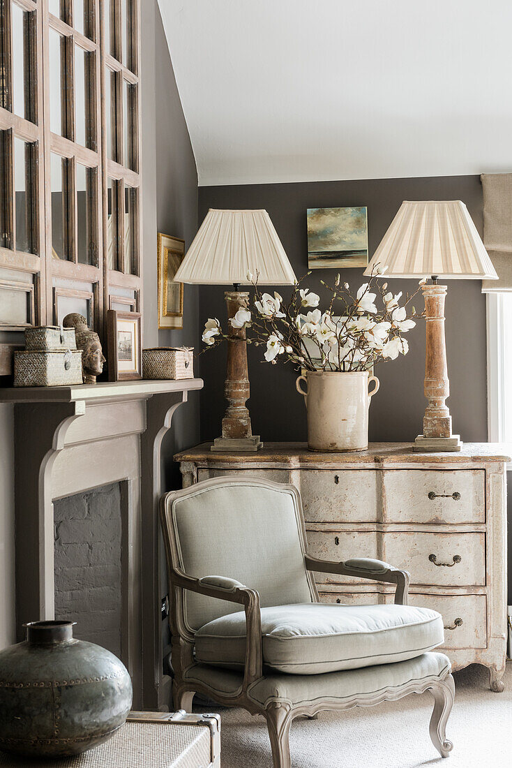 French armchair and chest of drawers by fireplace
