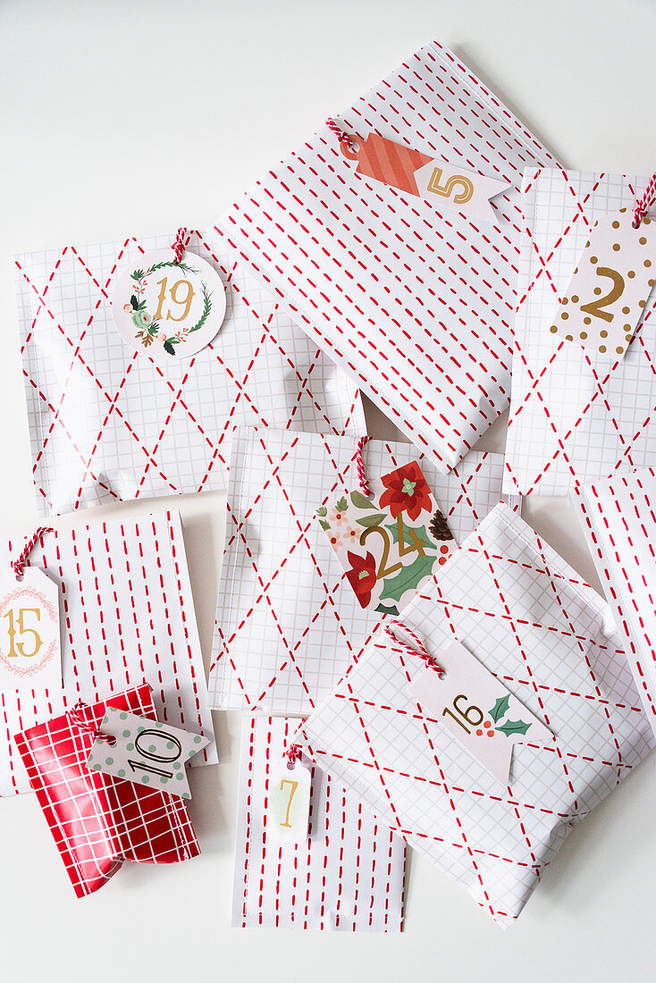 Gifts for an Advent calendar wrapped in hand-decorated paper