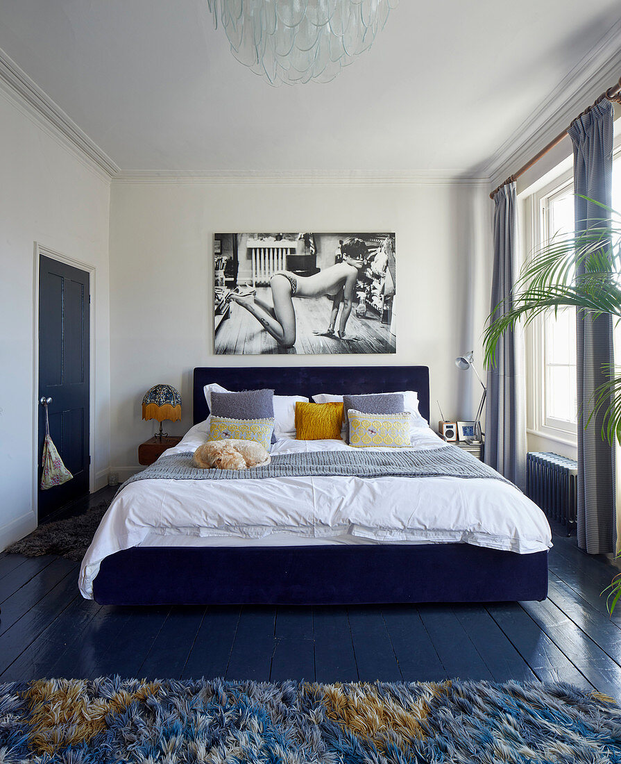 Black-and-white photo above bed in retro bedroom