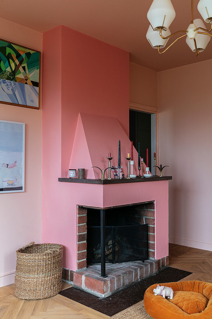 A fireplace in dusky pink in a living room