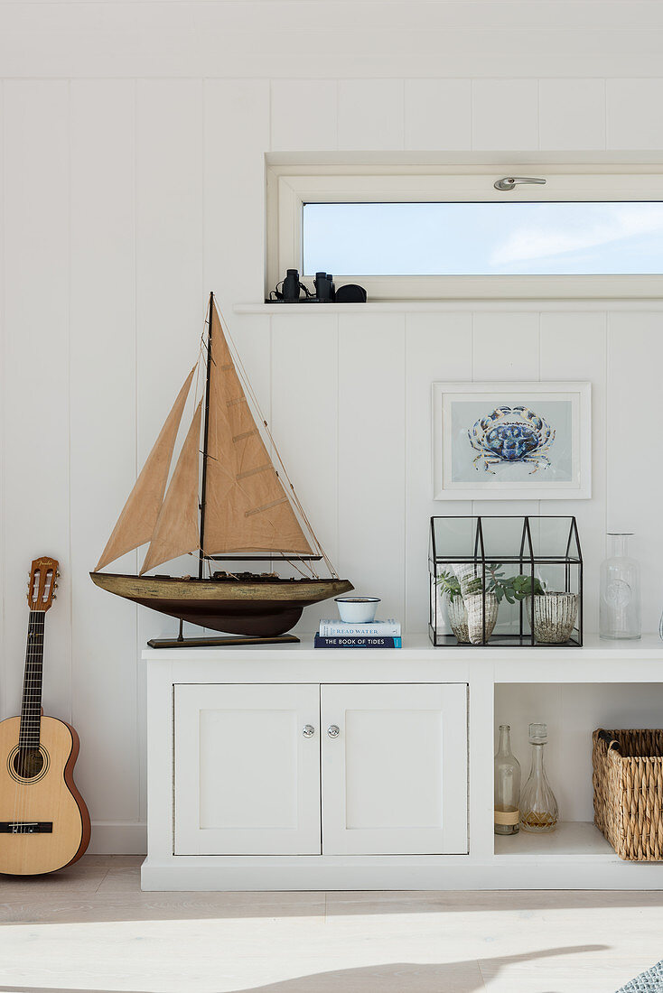 Wooden sailing boat with crab painting and guitar