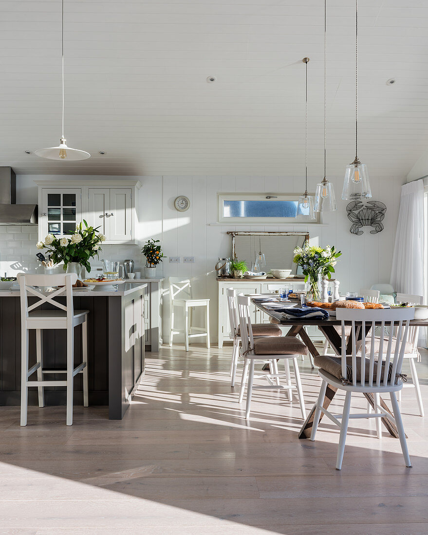 Open plan dining room in sunlit coastal home