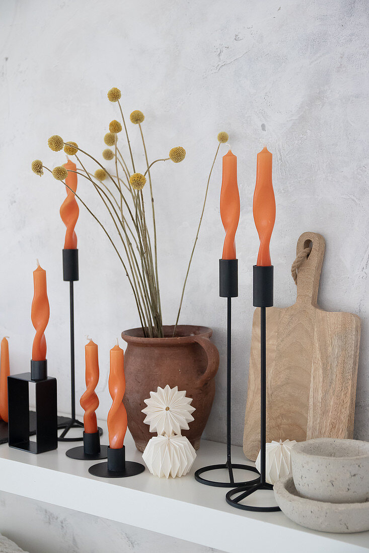 Arrangement of artistically twisted orange candles