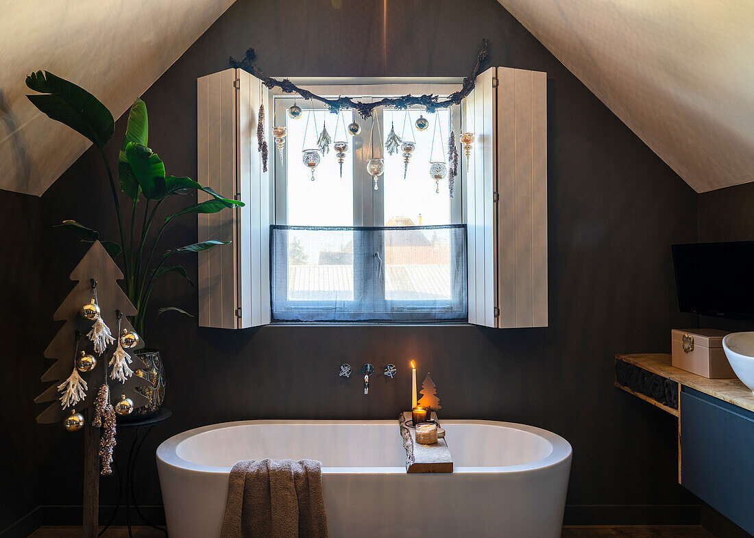 Freestanding bathtub and Christmas decorations in an attic bathroom