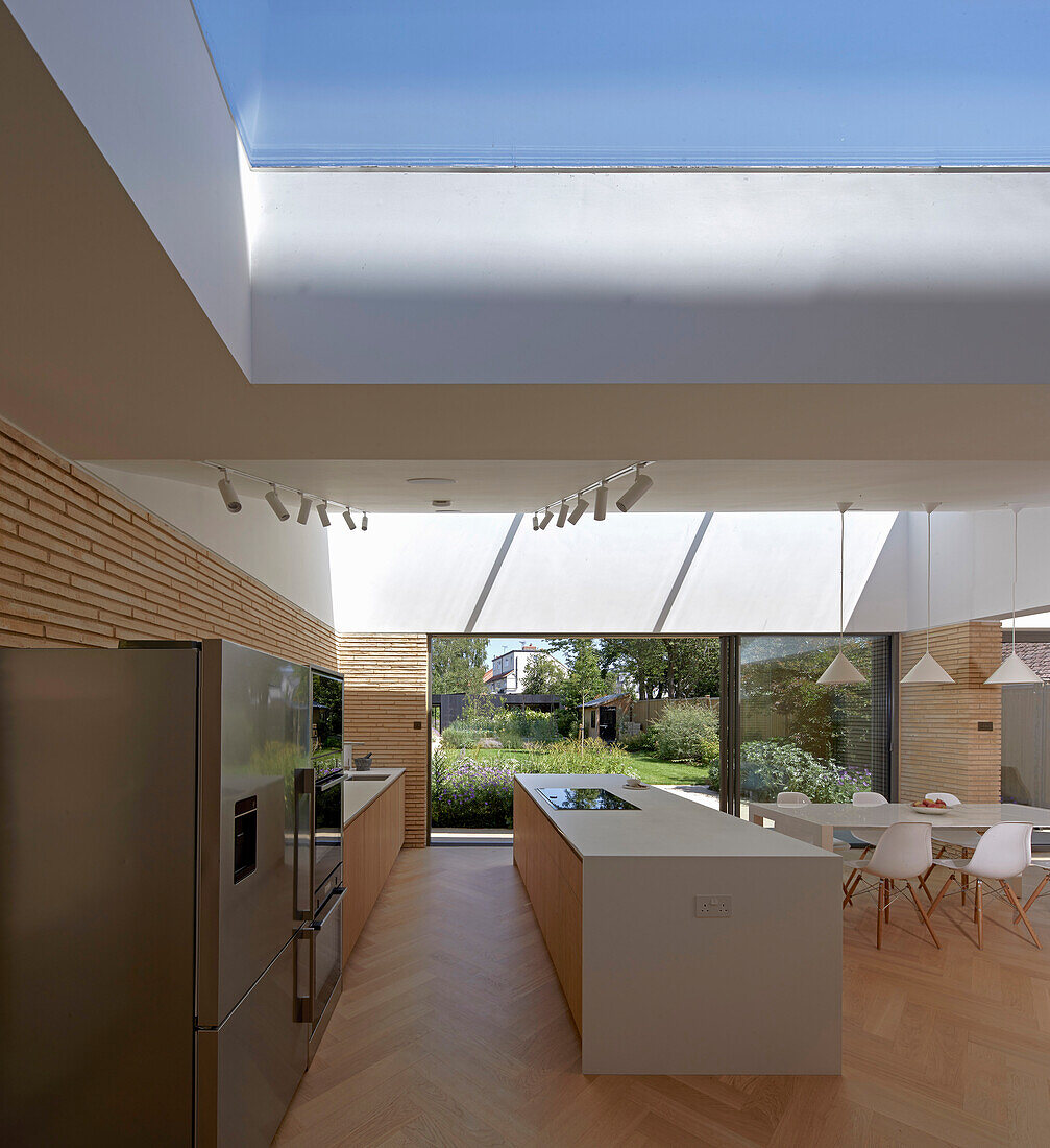 Moderne Küche und Essbereich in großzügigem Wohnraum mit Oberlicht