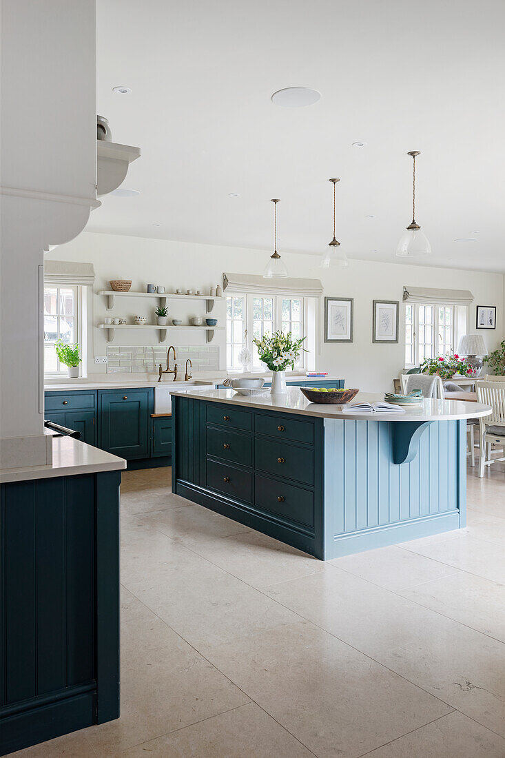 Spacious white kitchen, kitchen island with blue fronts