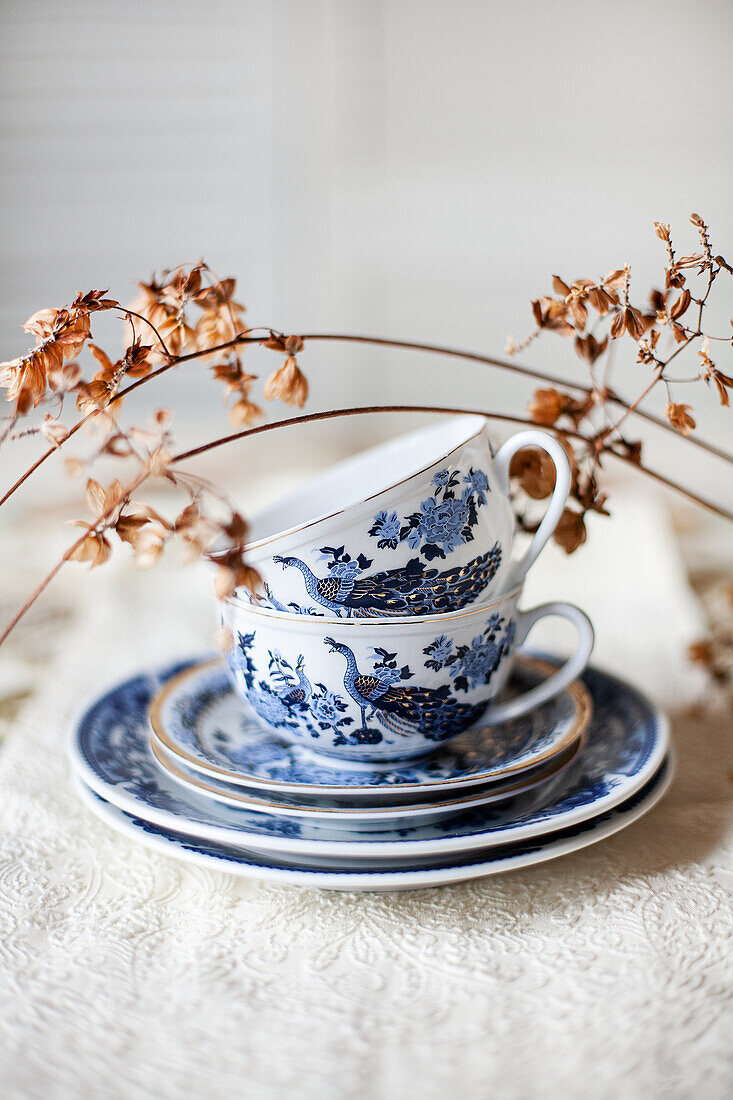 Porcelain cups and plates on embroidered tablecloths