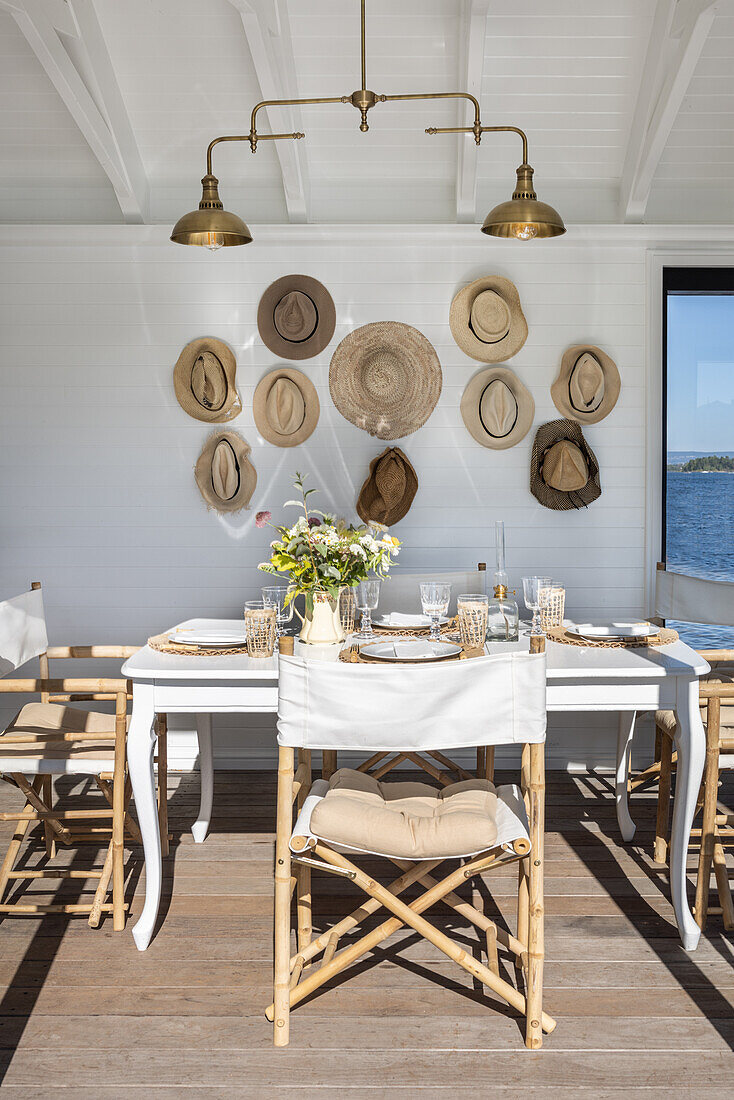 Sunny dining area and collection of hats in the wooden cottage