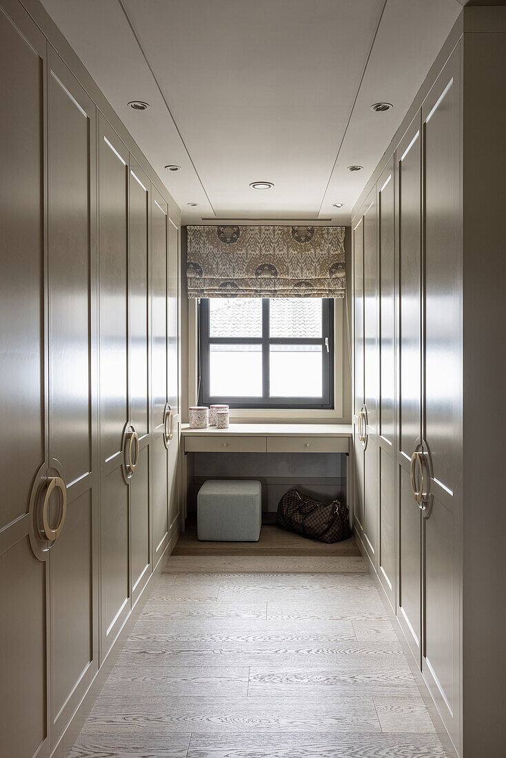 Changing room with floor-to-ceiling fitted wardrobes