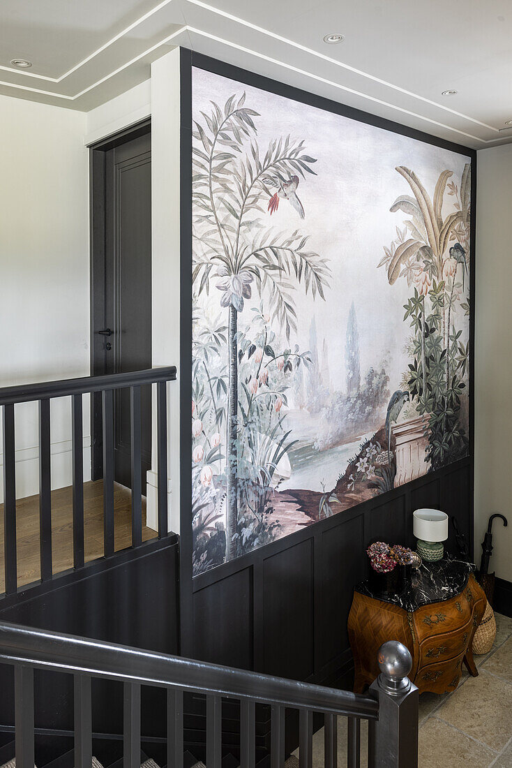 Staircase with black banister and poster with bird garden motif