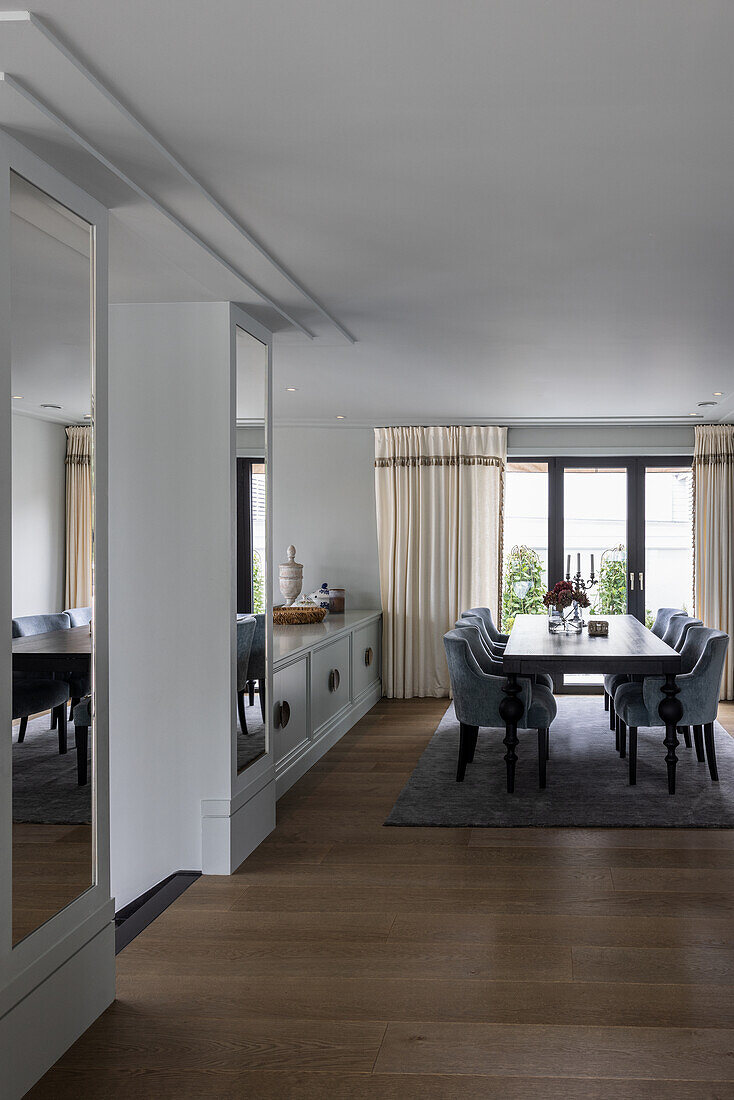 View of elegant dining area with upholstered shell chairs