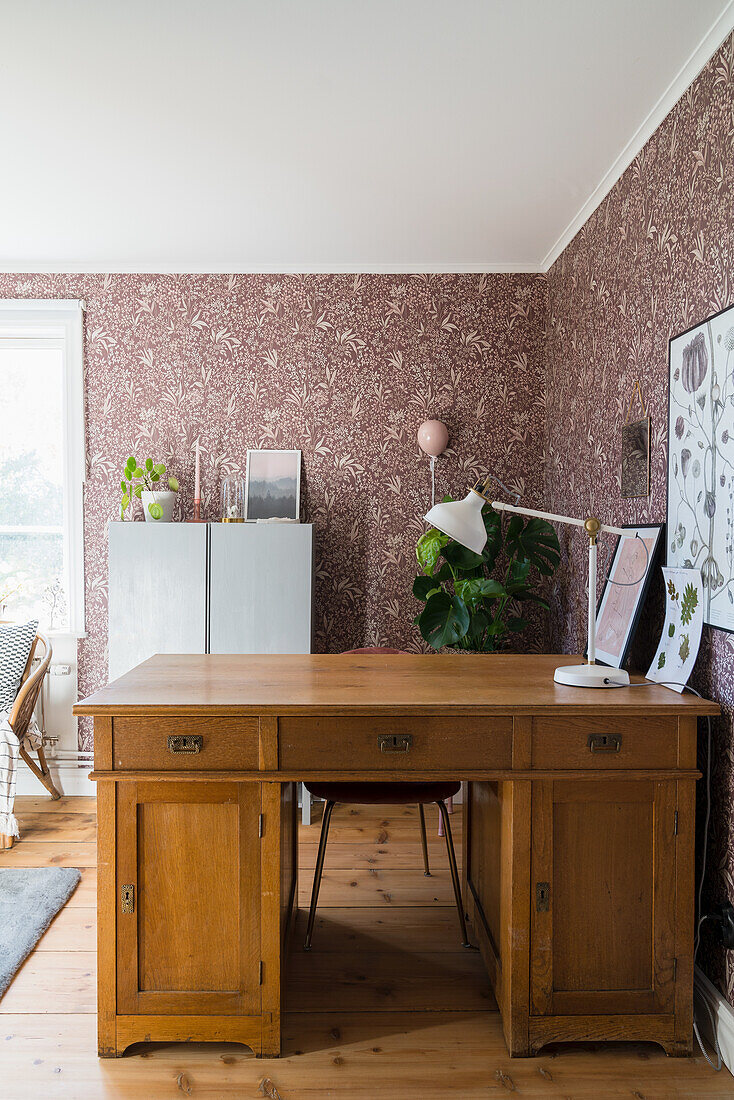 Solid desk in the study with floral wallpaper