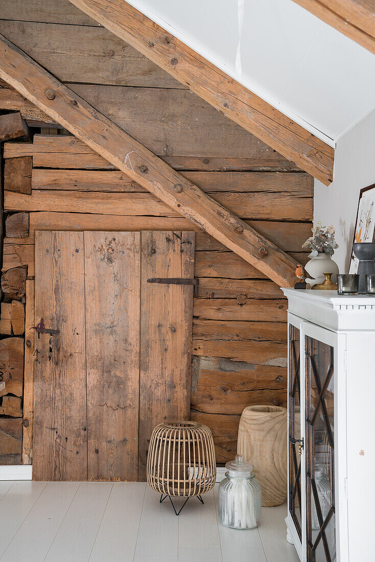 Wooden wall with wooden door in the attic room