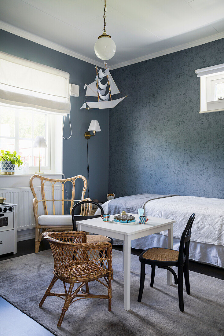 Children's room in blue-grey tones, with various seating furniture