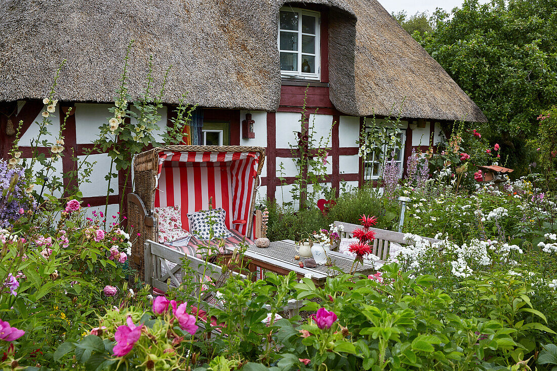 Idyllic cottage garden in front of a historic half timbered house in Ulsnis, Schleswig-Holstein, Germany