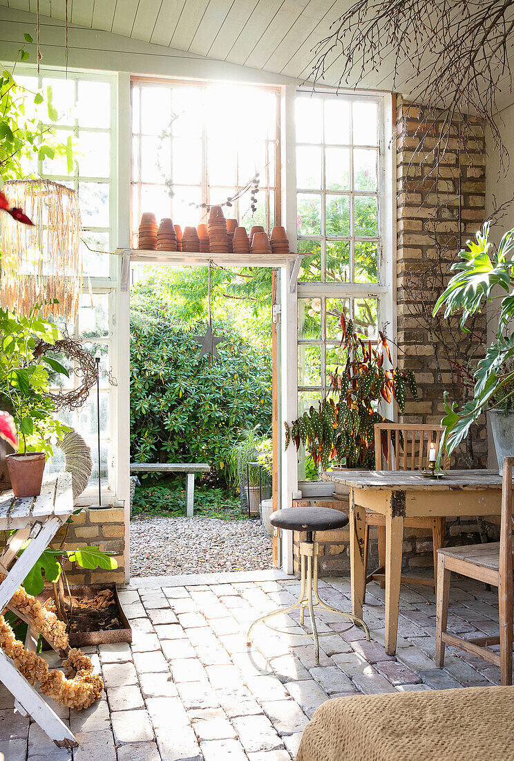 Plants, clay pots and seating area in the orangery